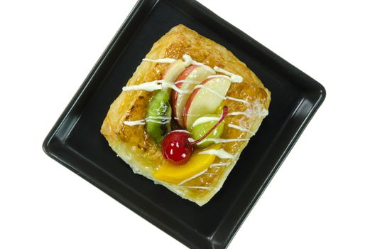 top view Apple Danish Topped With Glazed Fresh Fruit , sweet dessert on black dish