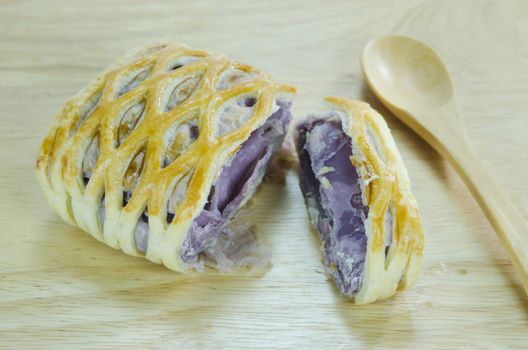 taro pies with wooden spoon on wooden background 