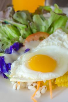 close up fried egg and fresh salad on dish
