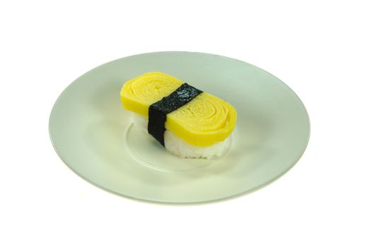 Tamago yaki is sushi using an egg, like a sushi omelette on dish