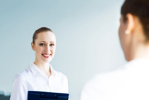 Young business woman talking with a colleague, interviews