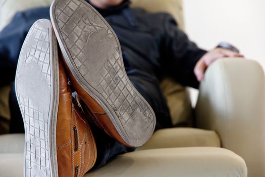 man lounging on armchair