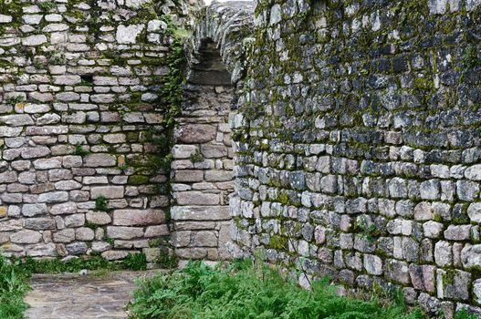 Arch in a very old granite stoned wall