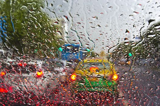 Raindrops on window. Blurred cityscape on a background.