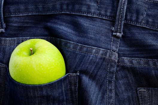 Green apple in Jeans pocket