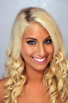 Close-up of an extraordinarily beautiful young blonde with a bright, warm smile.