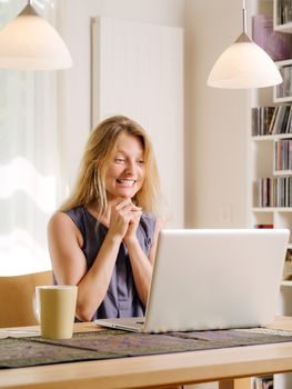 Photo of a beautiful young female excited about shopping online and drinking coffee. 