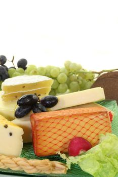 different types of cheese on a green glass plate