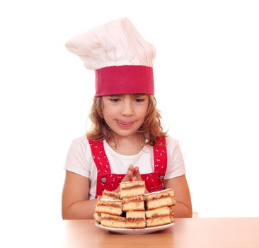 hungry little girl cook looking at apple cakes