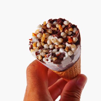 Ice cream cone in a male hand isolated over white background