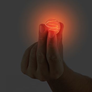 Glowing sphere held in a male hand