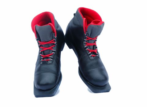 Leather black ski boots with a red lining. Are presented on a white background.