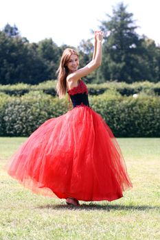 Young woman in a red gothic dress