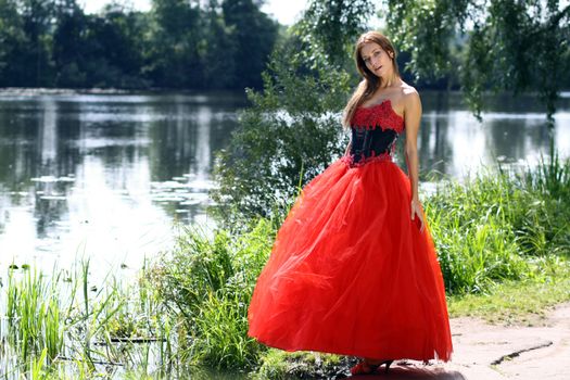 Young woman in a red gothic dress