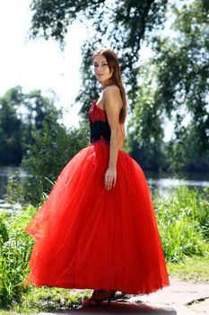 Young woman in a red gothic dress