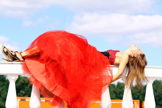Young woman in a red gothic dress