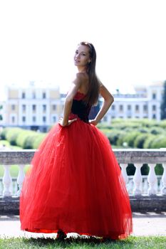 Young woman in a red gothic dress
