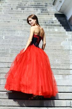 Young woman in a red gothic dress