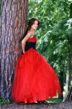 Young woman in a red gothic dress
