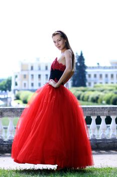 Young woman in a red gothic dress