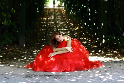 Young woman in a red gothic dress