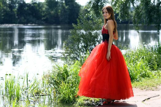 Young woman in a red gothic dress