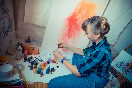 beautiful blonde woman painter in her studio