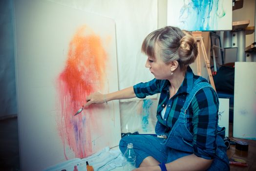 beautiful blonde woman painter in her studio