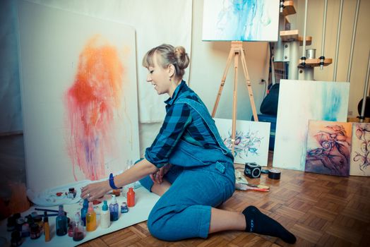 beautiful blonde woman painter in her studio