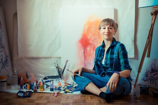 beautiful blonde woman painter in her studio