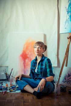 beautiful blonde woman painter in her studio