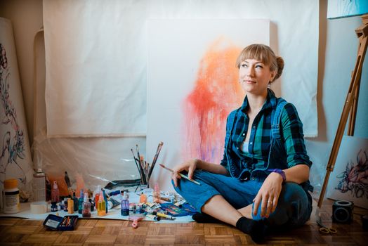 beautiful blonde woman painter in her studio