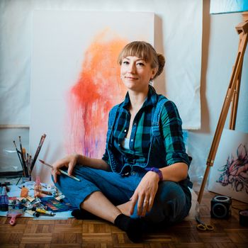 beautiful blonde woman painter in her studio