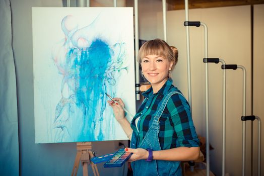 beautiful blonde woman painter in her studio