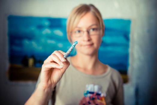 beautiful blonde woman painter in her studio