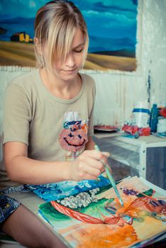 beautiful blonde woman painter in her studio