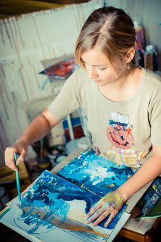 beautiful blonde woman painter in her studio