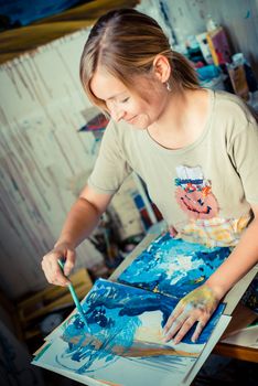 beautiful blonde woman painter in her studio