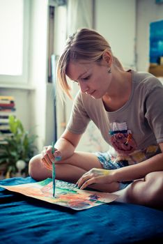 beautiful blonde woman painter in her studio