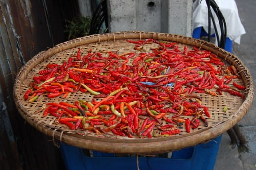 Thai red peppers on a wooden box on the street