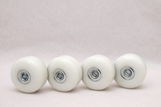 4 white Skate wheels on a clear background