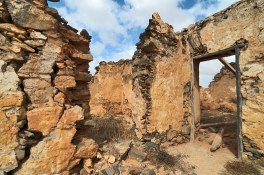 Old ancient building in the desert on a cloudy sky