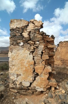 Old ancient building in the desert on a cloudy sky