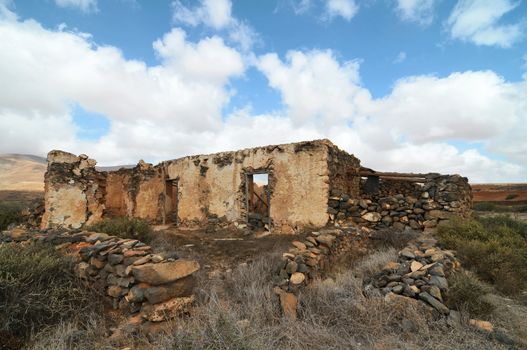 Old ancient building in the desert on a cloudy sky