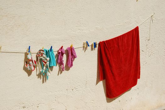 clothes hanging on a wire over a wall