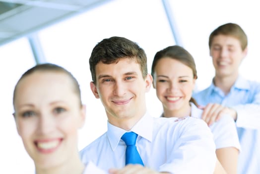 portrait of a young businessman standing in a row with his colleagues, concept of teamwork