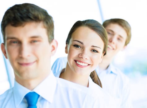 portrait of a young business woman standing in line with colleagues, concept of teamwork