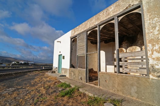 Abandoned building in the desert on a cloudy sky