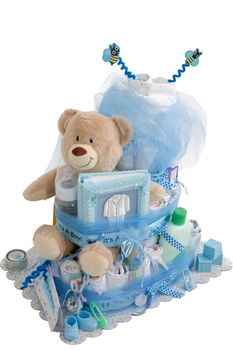 Isolated baby diaper cake present with different items for the expectant family. It is set with blue colors that for a boy
