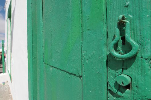 Aged green wooden door with lock ,in Tenerife, Spain